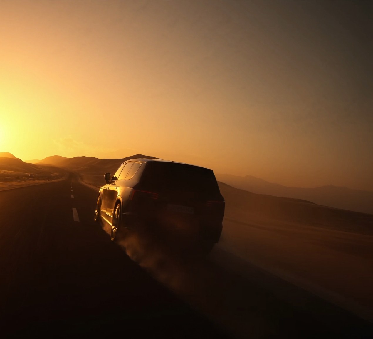 Vehicle departing on a UAE desert highway at golden hour